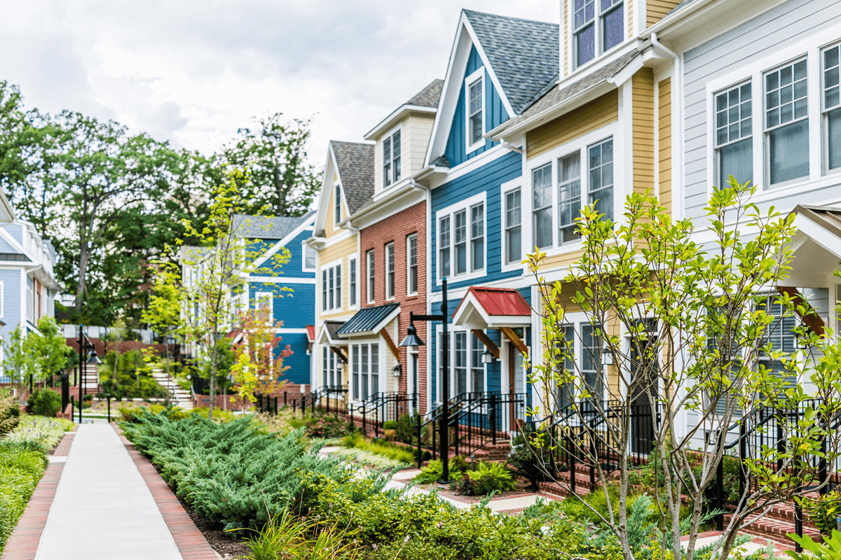 Colorful townhouses with landscaped path.
